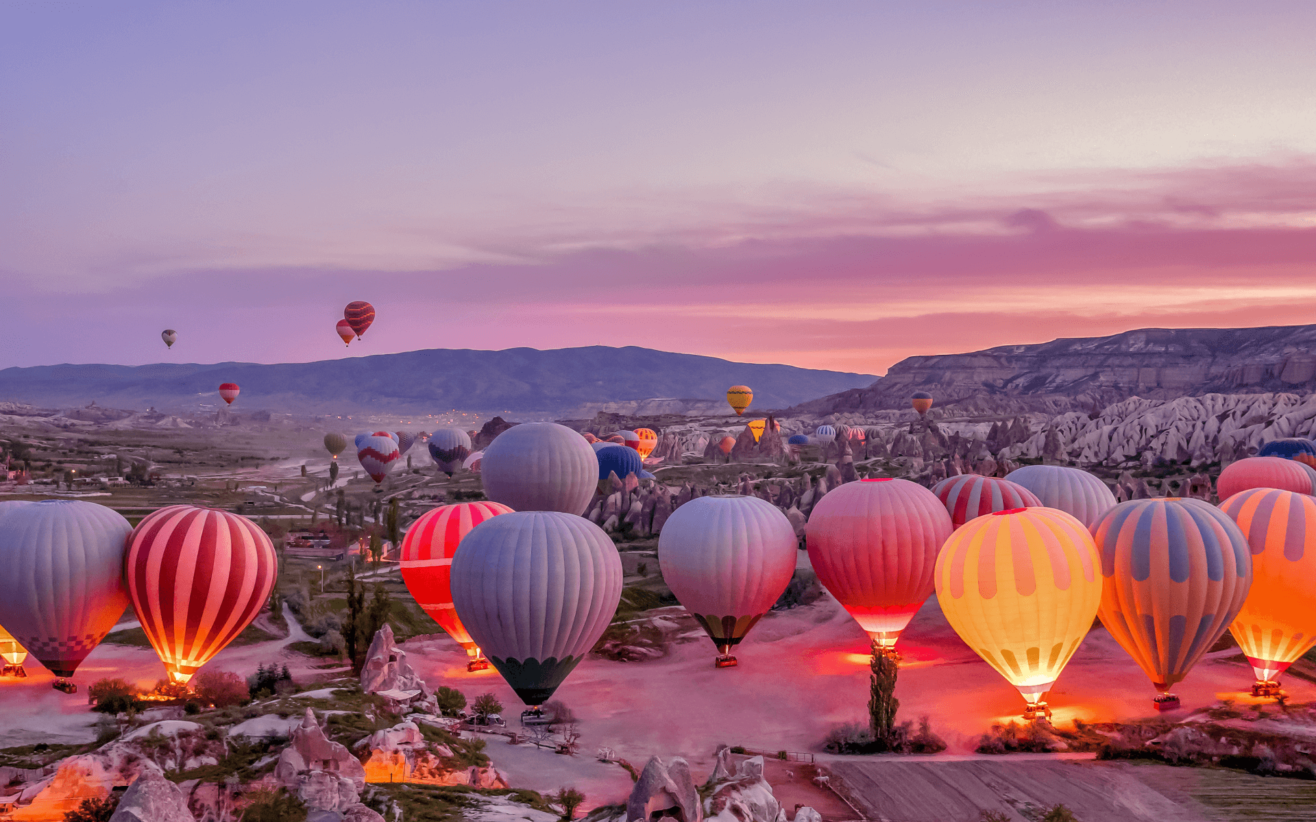 Cappadocia hot air balloon tour at sunrise over the volcanic landscape