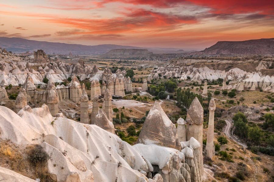 Four seasons in Cappadocia - fairy chimneys with snow, spring flowers, summer balloons, and autumn golden colors